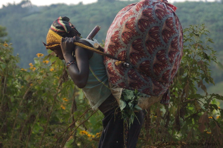Women such as this carry heavy loads to trade in town and are frequently raped by the armed groups, as a means of intimidation and control.