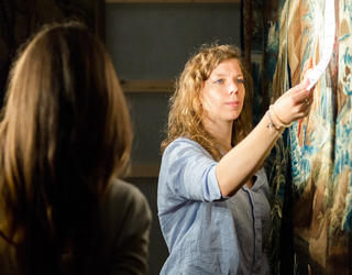 Deux chercheurs travaillent sur une tapisserie pour en étudier les couleurs